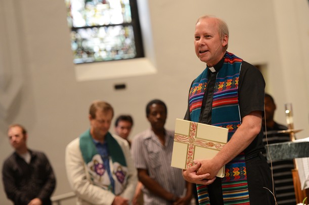Fr. Dan Reim, of St. Mary's Student Parish addresses the audience during a prayer vigil in support of Camp Take Notice at the church on Thursday night. Melanie Maxwell I AnnArbor.com